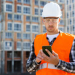 medium shot engineer looking phone