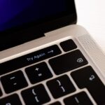 Laptop met Windows-activeringsscherm, iemand die een licentiekey controleert